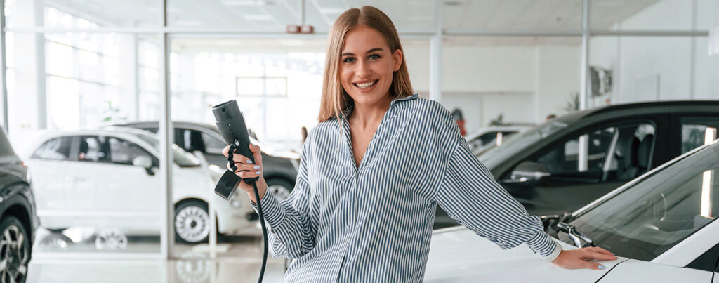 a woman holding a black device